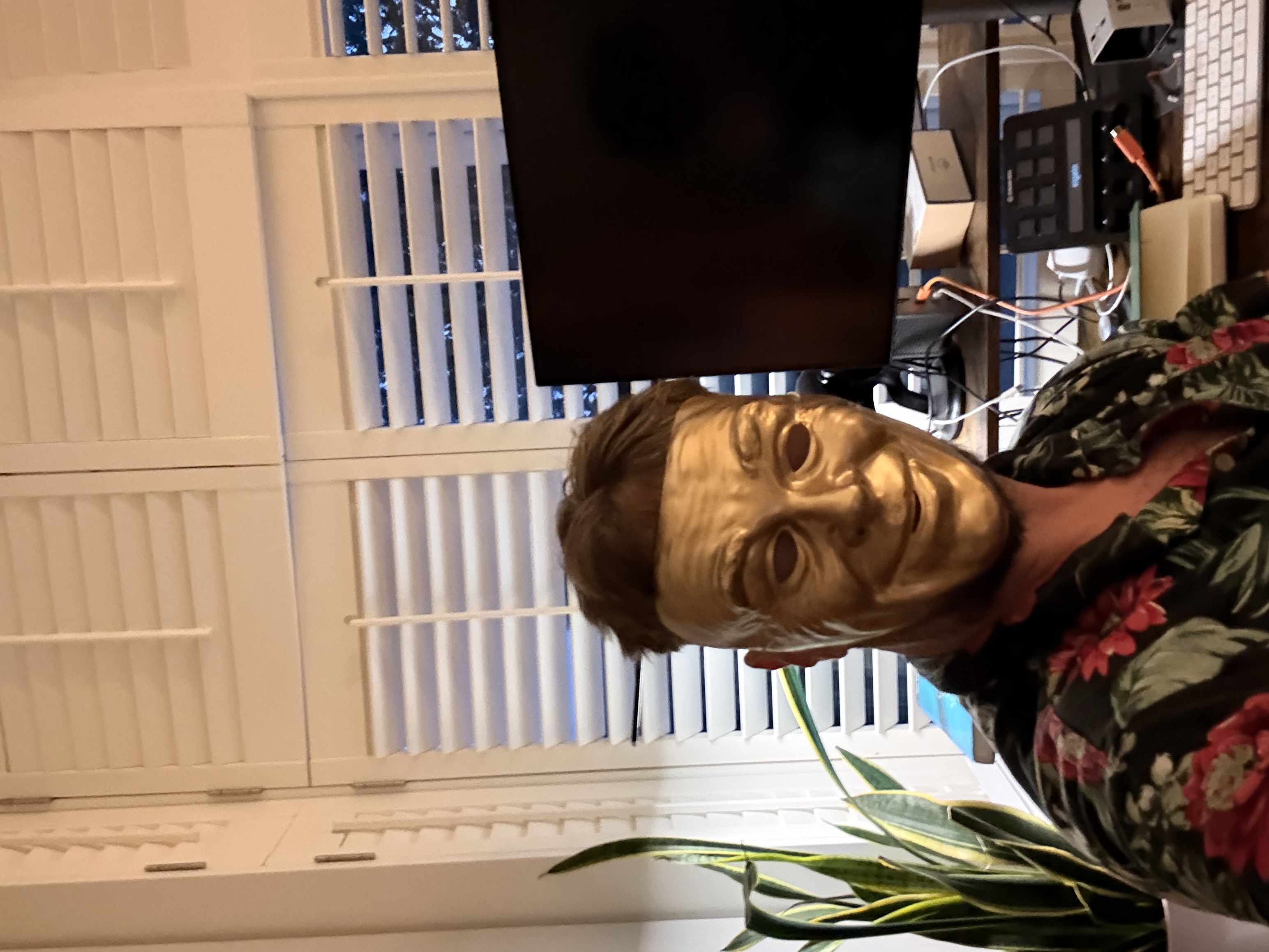 Deleted Time’s creator wearing a gold mask and floral shirt